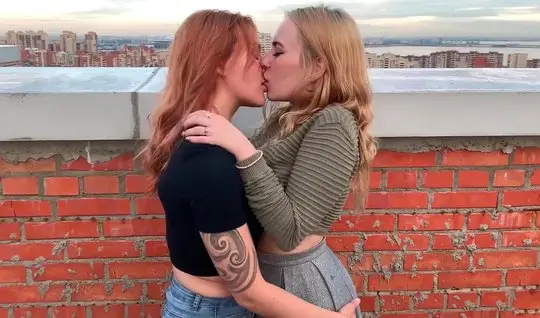 Russian lesbians on the roof of the house gently kiss and fuck each ot...
